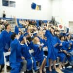 Students from SDJA 2025 graduating class toss their caps in the air at the conclusion of the graduation ceremony