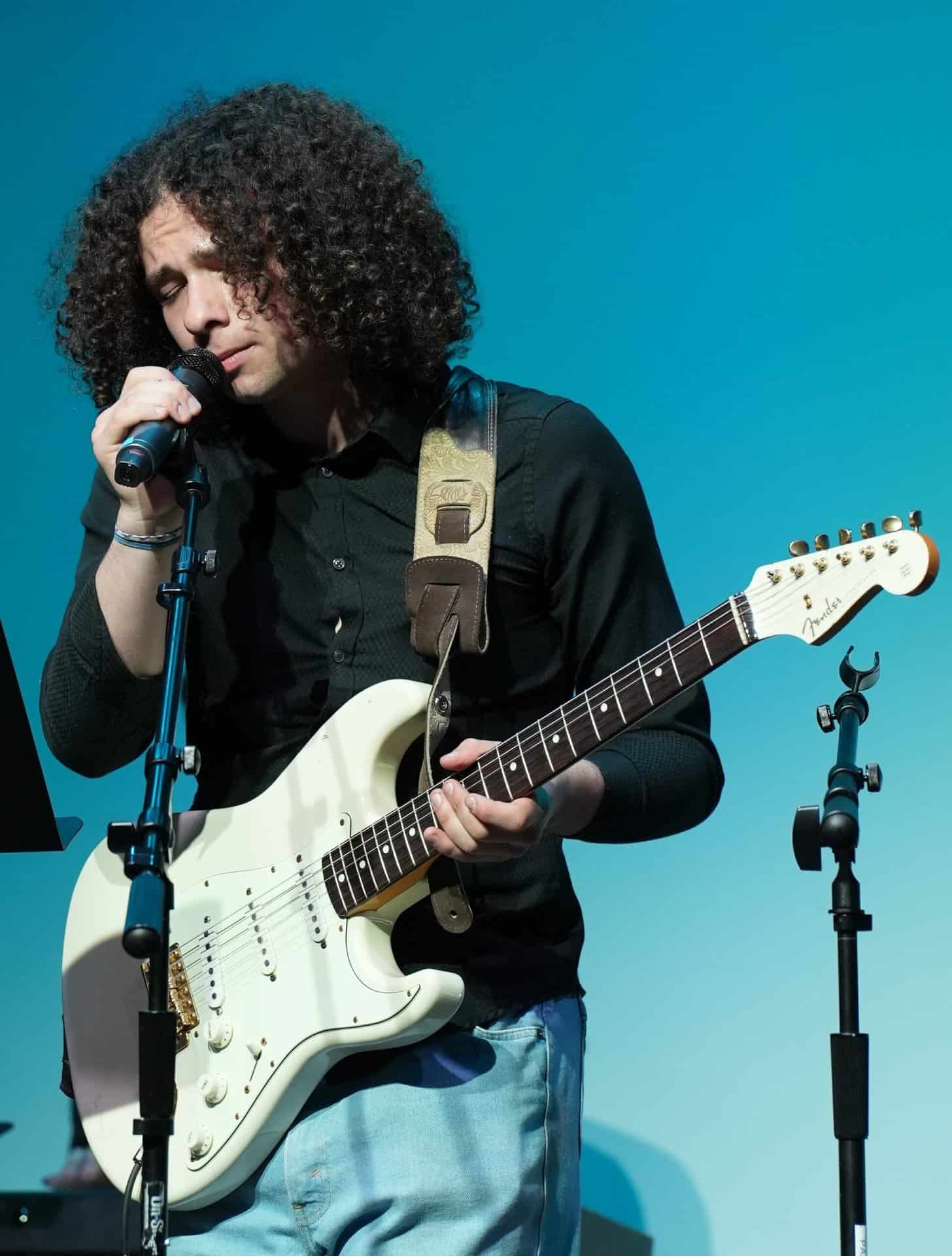 Upper Schooll student playing guitar.