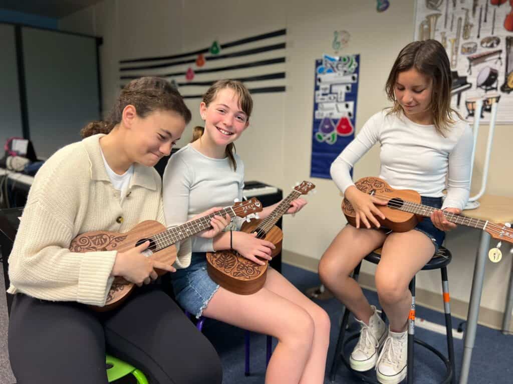 SDJA students playing ukulele during music class