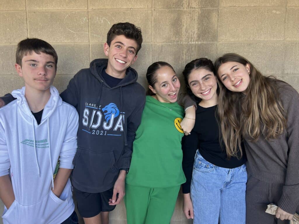 A group of upper school students pose at school