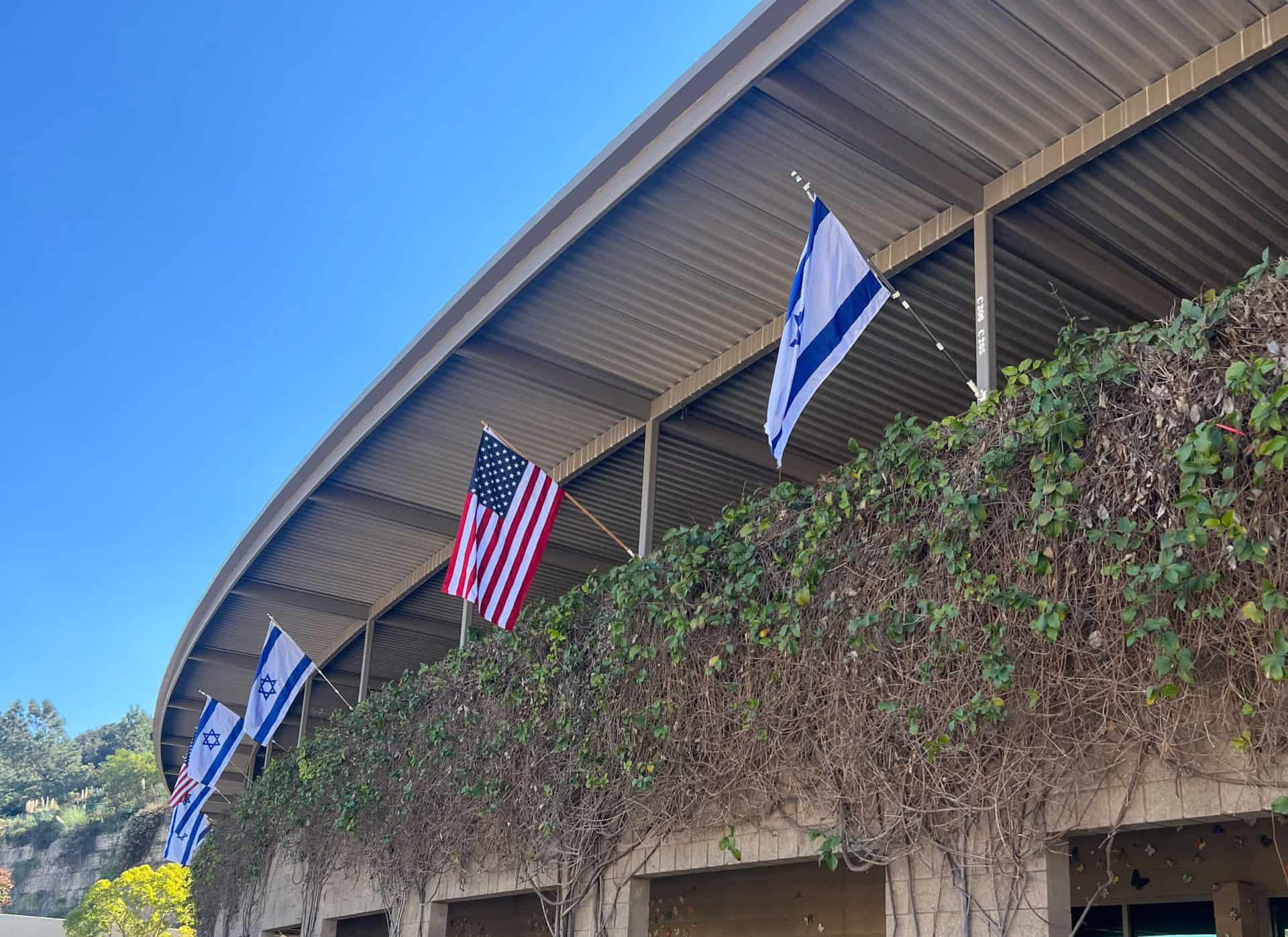 SDJA building facade with Israeli and American flags