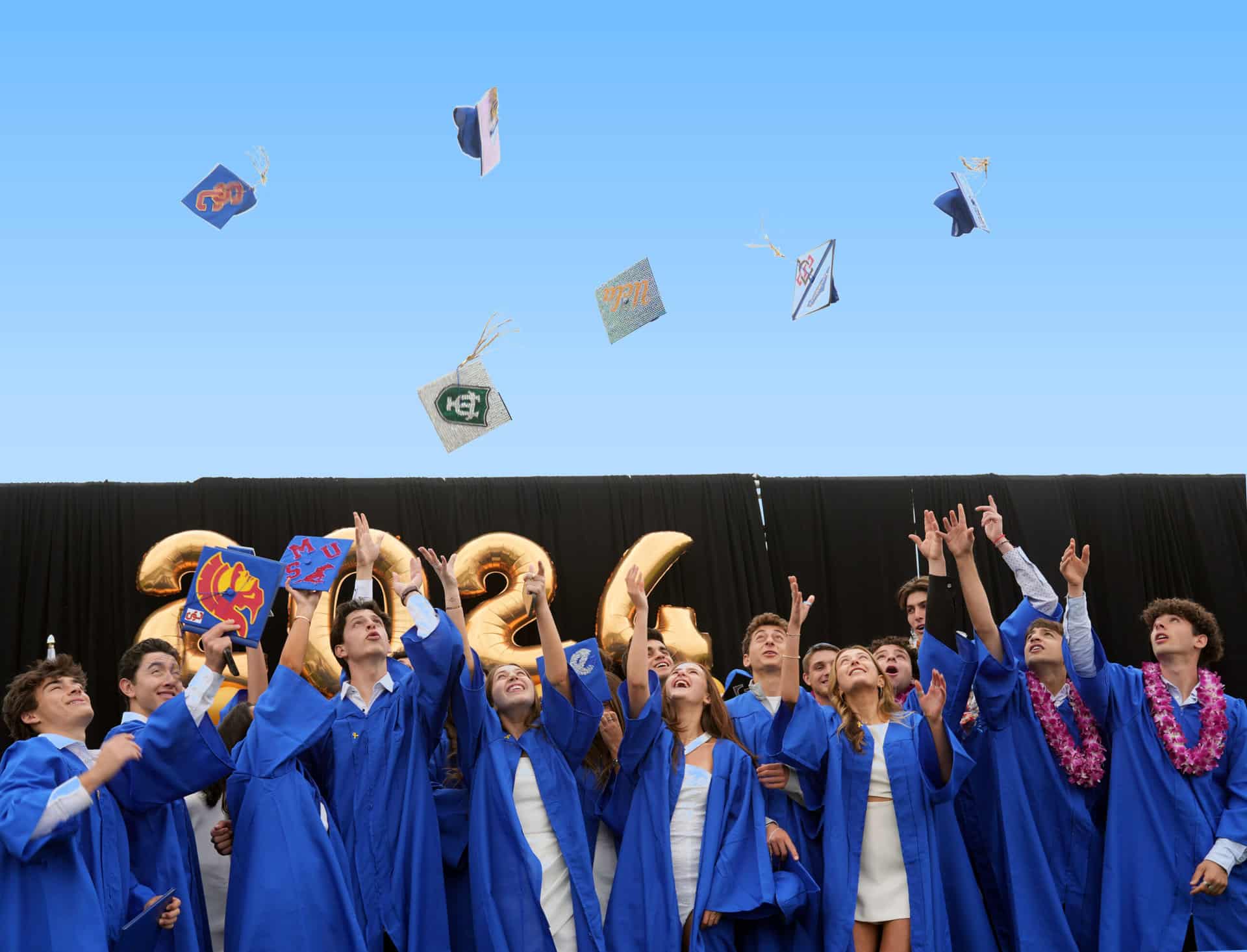 SDJA graduates throwing their hats in the air.