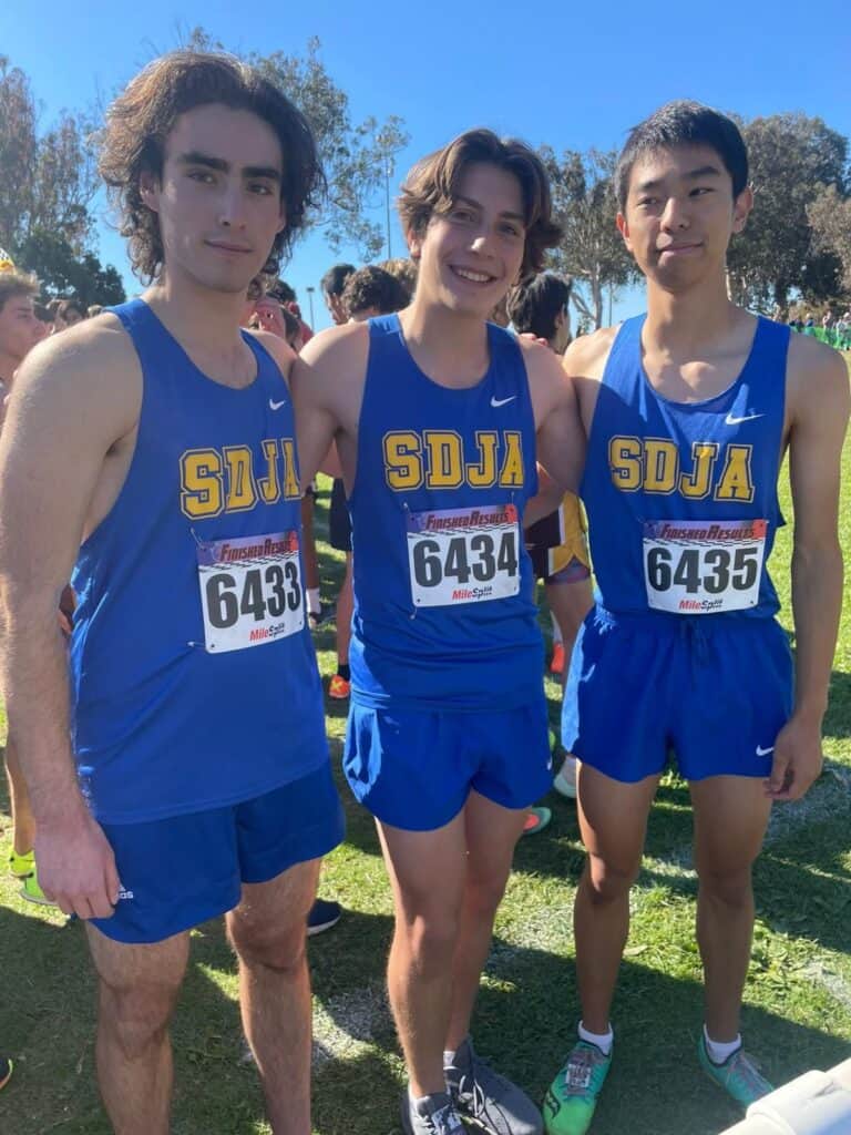 Cross country runners pose together after a meet.