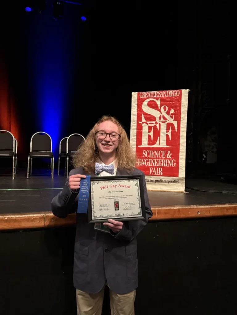 An SDJA student poses with their award at the Greater San Diego Science and Engineering Fair