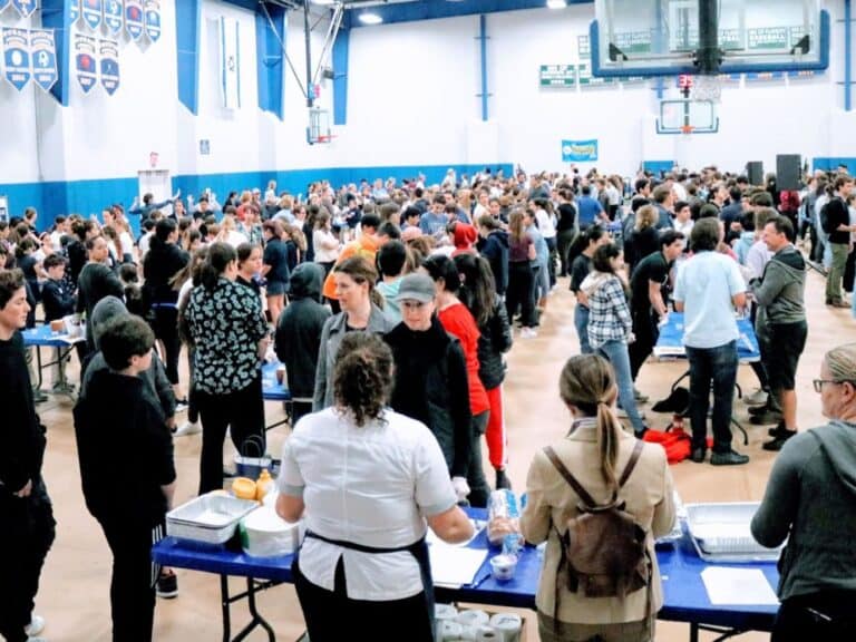 SDJA students gather in the school's gym to make sandwiches.
