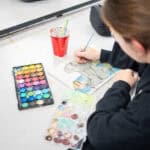 SDJA student working on a watercolor painting of an elephant