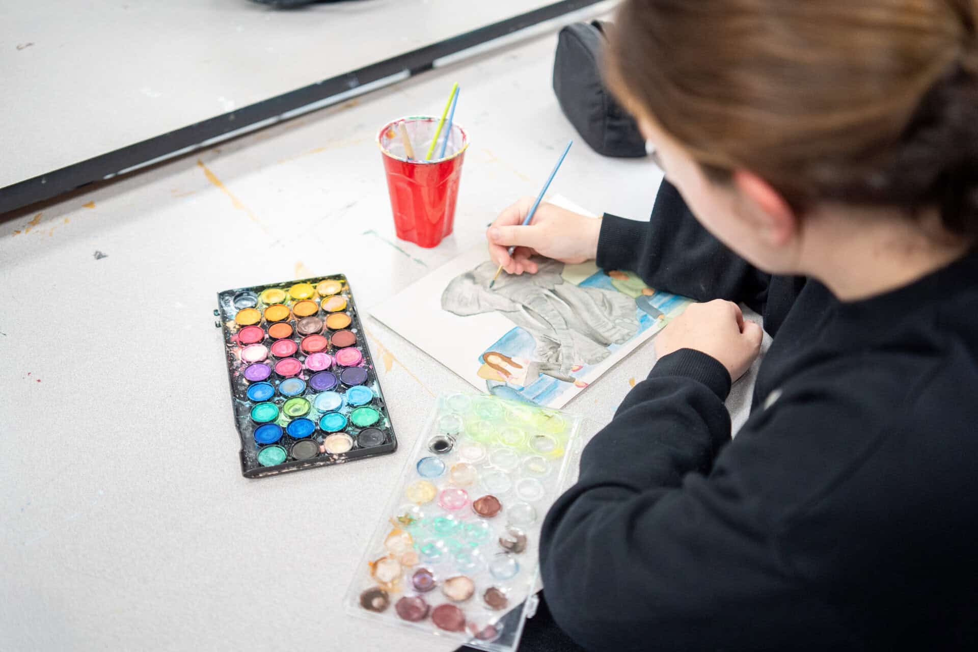 SDJA student working on a watercolor painting of an elephant
