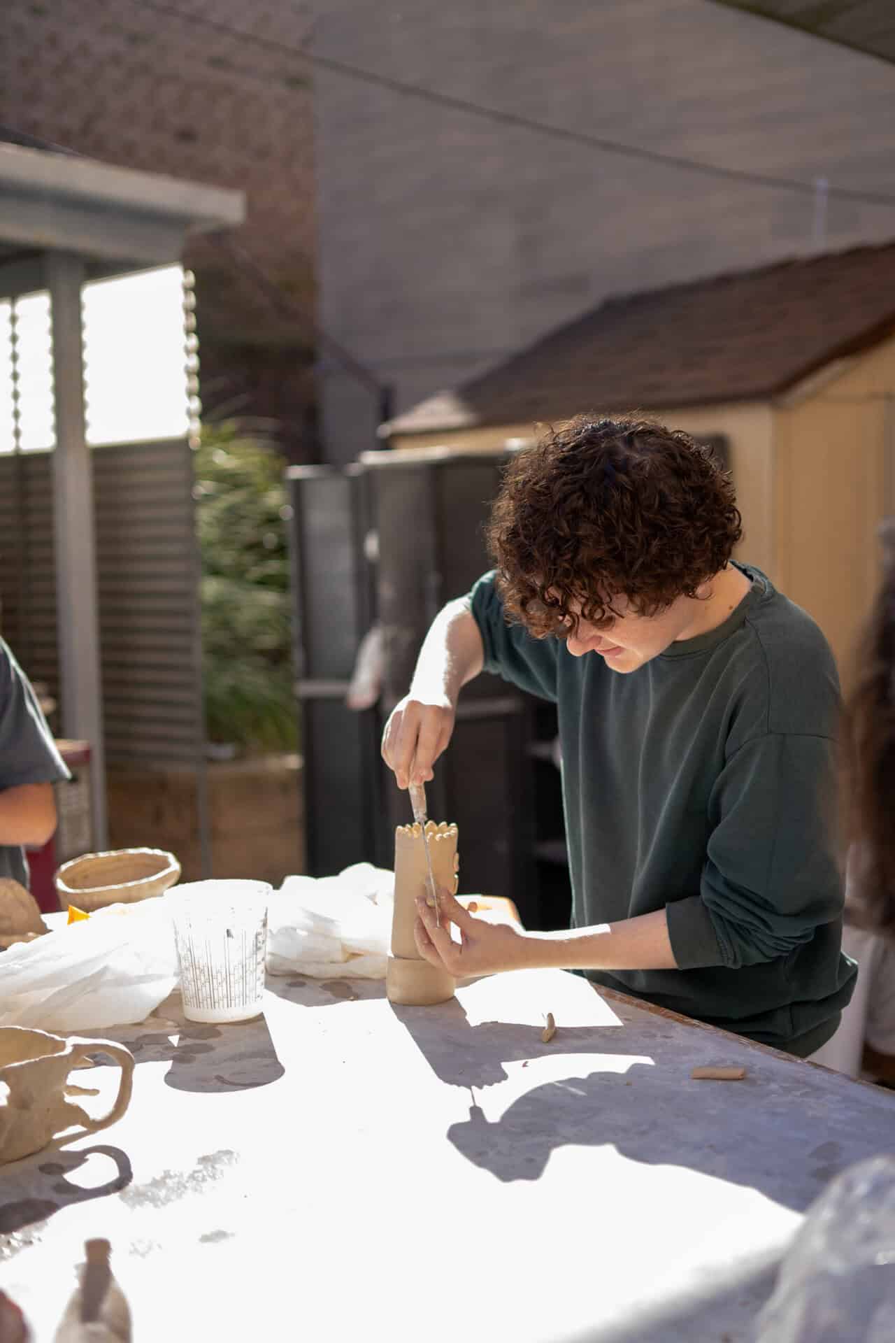 A boy making a ceramic piece of art