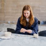 A girl making a clay sculpture