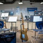 Guitars, amps, and music stands set up in the SDJA music room