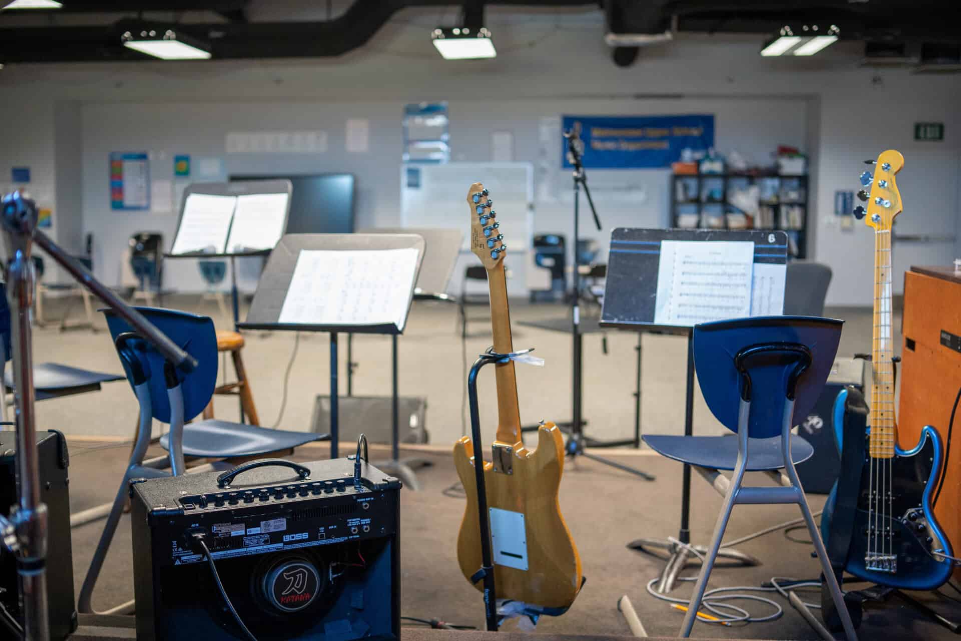Guitars, amps, and music stands set up in the SDJA music room