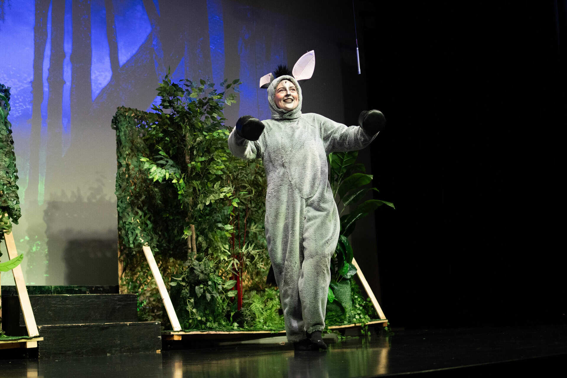 A person dressed in costume as a mouse during a school performance