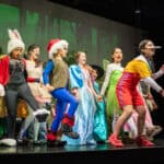 SDJA students dressed in costume, performing a musical on stage