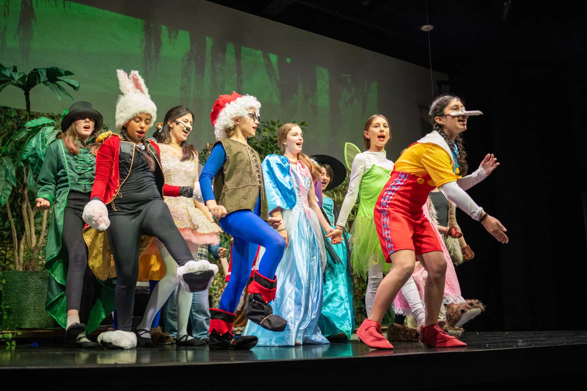 SDJA students dressed in costume, performing a musical on stage