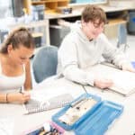 Upper school students making sketches at a table