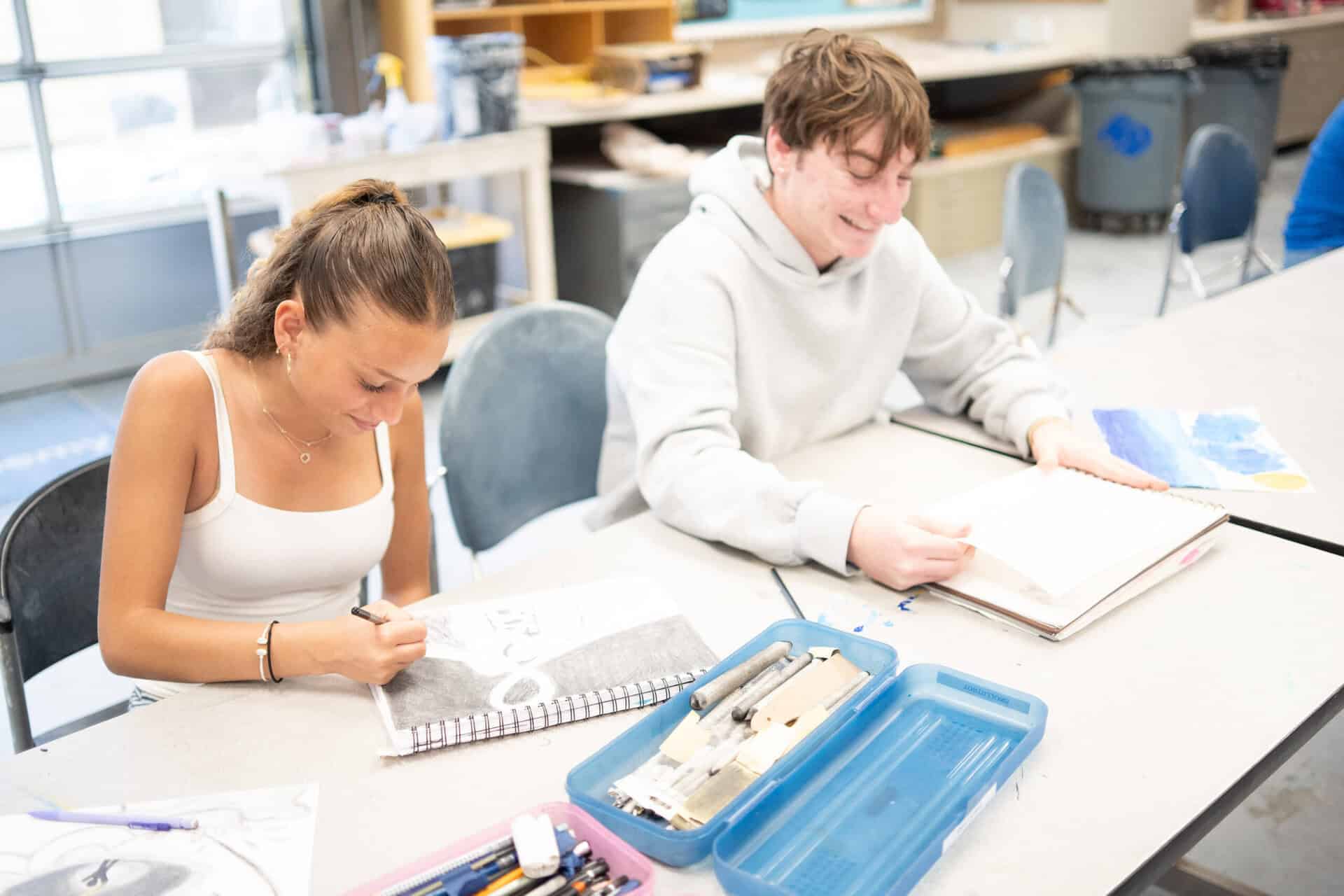 Upper school students making sketches at a table