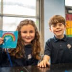 SDJA lower school students show off a stitched art piece