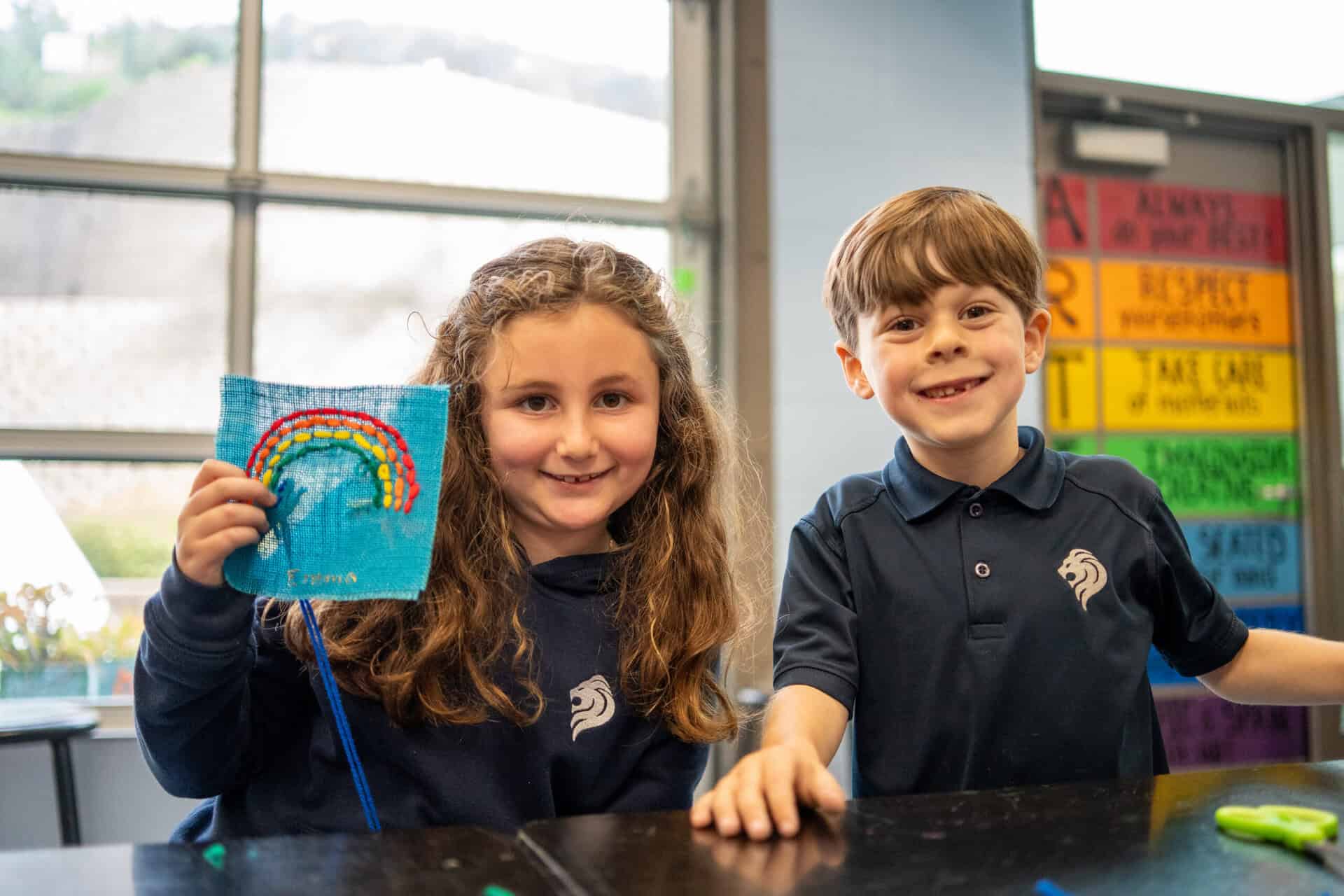 SDJA lower school students show off a stitched art piece