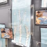 Artwork of birch trees hanging on a wall during an SDJA art show