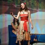 A girl on stage as Moana during a school play