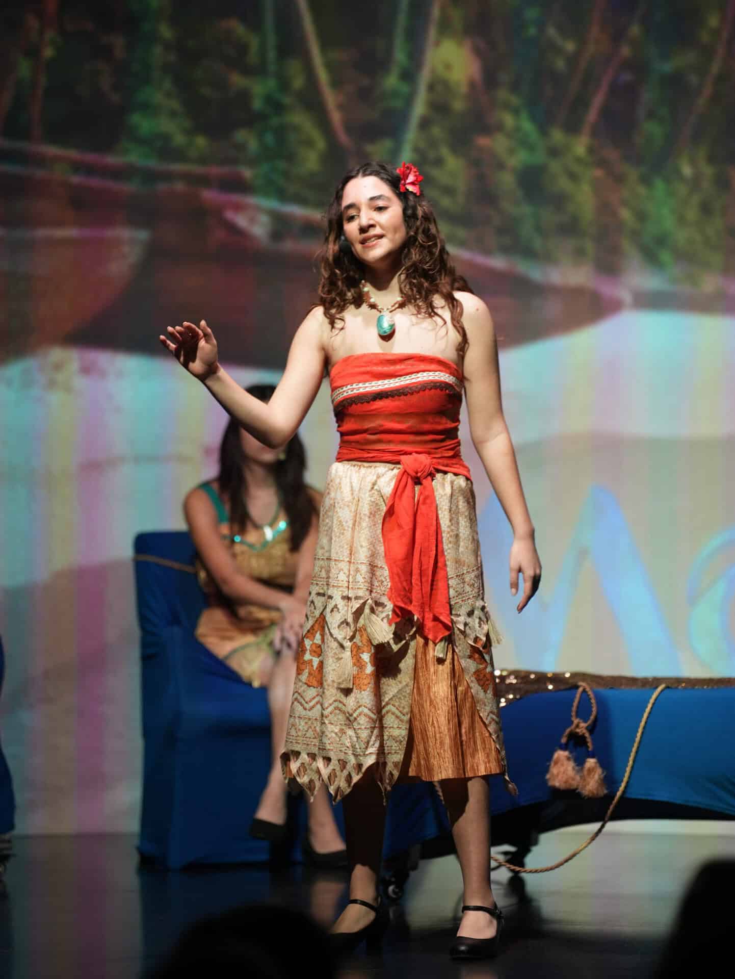 A girl on stage as Moana during a school play