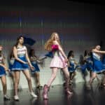 SDJA students dressed a cheerleaders performing Legally Blonde on stage