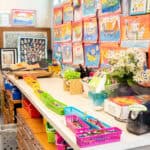 The counters and walls of the lower school art classroom, with baskets of pencils and hanging art pieces