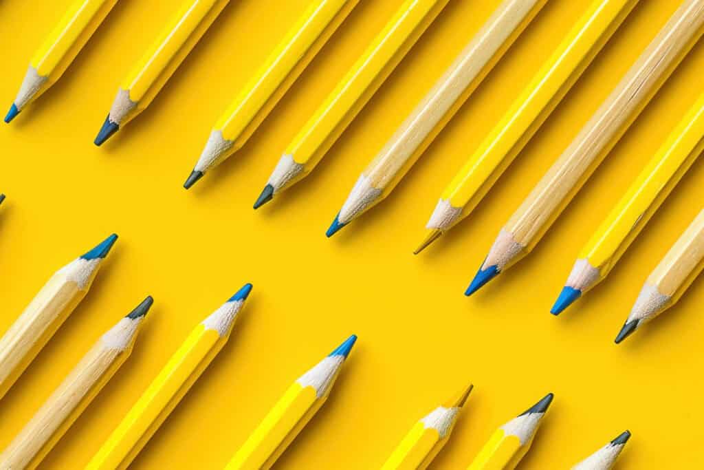Yellow pencils lined up against a yellow background