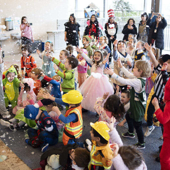 Preschool Purim Preschoolers in costumes for Purim, playing with bubbles